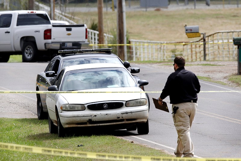 
              Investigators work at the scene Monday, March 27, 2017, where a Tecumseh, Okla. police officer was shot during a traffic stop overnight. Officer Justin Terney died Monday morning after undergoing surgery overnight, Tecumseh Assistant Police Chief J.R. Kidney said. The suspect was also shot and was in intensive care Monday morning, Kidney said.  (Jim Beckel/The Oklahoman via AP)
            