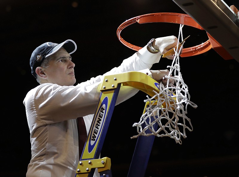 
              South Carolina head coach Frank Martin cuts down the net after beating Florida 77-70 in the East Regional championship game of the NCAA men's college basketball tournament, Sunday, March 26, 2017, in New York. (AP Photo/Julio Cortez)
            