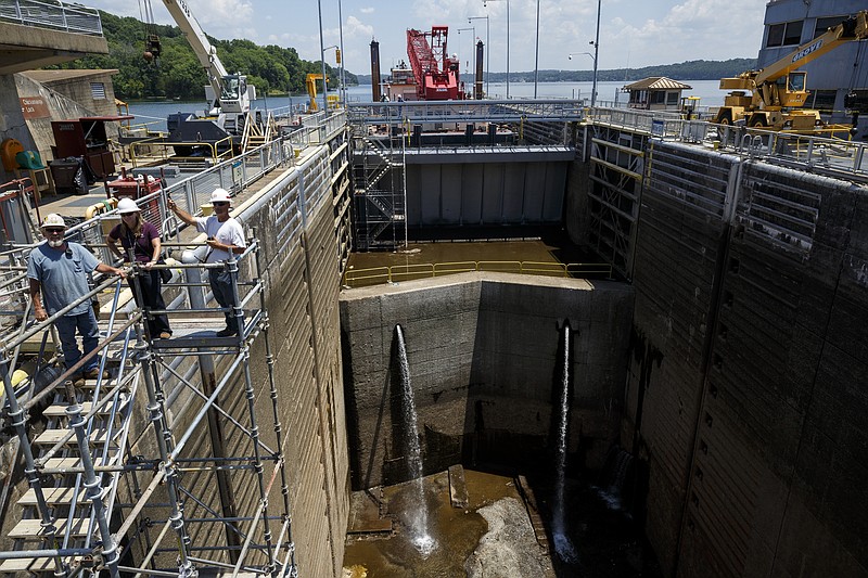 Workers direct a crane above the empty Chickamauga lock at the Chickamauga Dam in 2016.