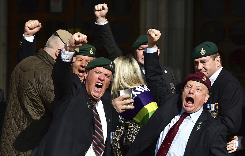 
              Supporters of Alexander Blackman celebrate outside the Royal Courts of Justice in London, Tuesday, March, 28, 2017. A British court has shortened the sentence of Royal Marine Blackman, convicted of killing a wounded Taliban fighter in Afghanistan. (Dominic Lipinski/PA via AP)
            