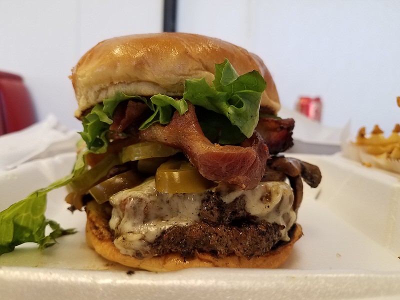 Although this mountain of food is huge, it's not Heart Attack Shack's biggest burger. That's the one-pound burger, which involves four patties stacked high. Not for the faint of heart.