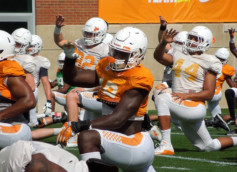 Darrell Taylor, center, takes a knee during the Vols' fourth spring practice on Tuesday, March 28, 2017. The 6-foot-4 defensive end is hoping to prove himself this year.