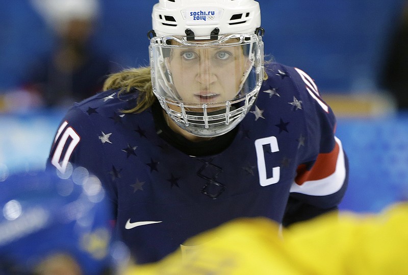 
              FILE - In this Feb. 17, 2014, file photo, Meghan Duggan of the United States looks up during a face off during the second period of the 2014 Winter Olympics women's semifinal ice hockey game against Sweden at Shayba Arena in Sochi, Russia. USA Hockey has reached a wage agreement with women's national team players to avoid a boycott of the world championships. USA Hockey announced the agreement Tuesday, March 28, 2017. (AP Photo/Mark Humphrey, File)
            