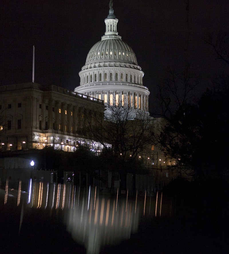 
              The illuminated Capitol Dome is reflected off the top of parked cars before dawn in Washington, Tuesday, March 28, 2017. (AP Photo/J. Scott Applewhite)
            
