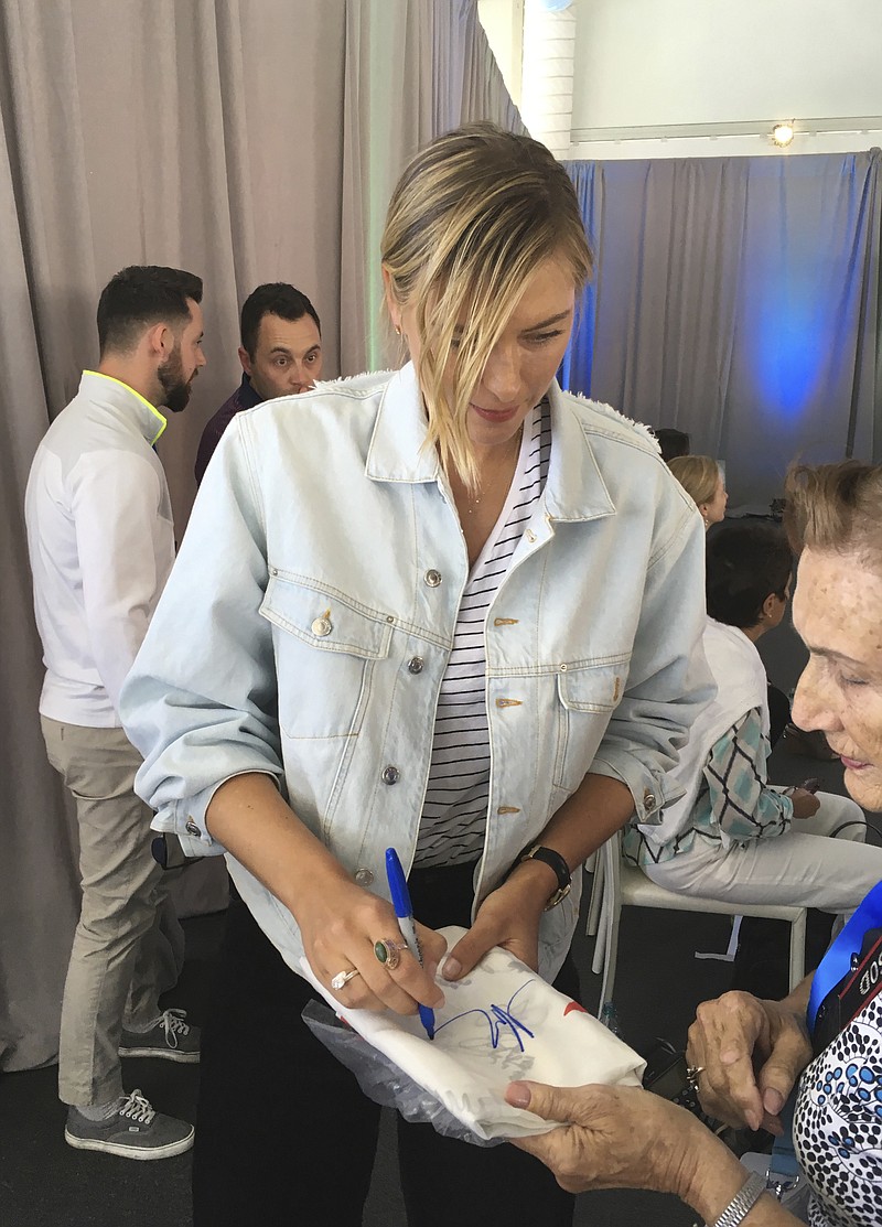 
              Maria Sharapova signs autographs at a sports conference as she nears the end of her 15-month doping suspension in Rancho Mirage, Calif., on Tuesday, March 28, 2017. The former No. 1 player plans to return to tennis next month at a tournament in Germany. (AP Photo/Greg Beacham)
            