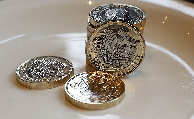
              New 12-sided £1 coins in Liverpool, England, Tuesday, March 28, 2017. A new 12-sided British pound coin is entering circulation amid concern that the round pound was too easy to counterfeit. (Peter Byrne/PA via AP)
            