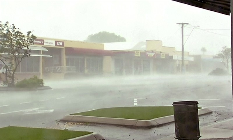 
              In this image made from video, wind gusts outside shops in Bowen, eastern Australia, Tuesday, March 28, 2017.  A powerful cyclone lashed islands, damaged roofs and cut power on Tuesday as it edged toward Australia's tropical northeast coast, officials said.(AuBC via AP)
            