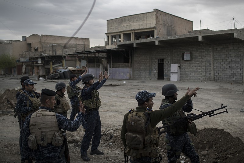 
              Federal Police soldiers gesture to other soldiers near the old city, during fighting against Islamic State militants on the western side of in Mosul, Iraq, Tuesday, March 28, 2017. (AP Photo/Felipe Dana)
            