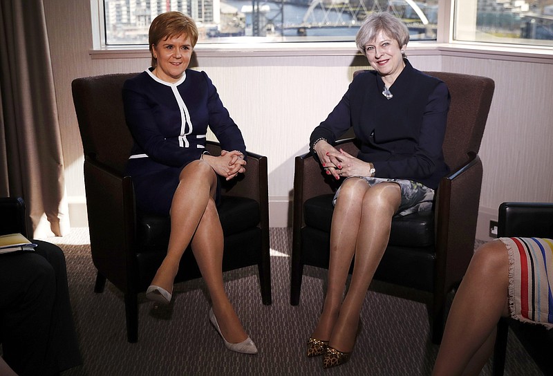 
              Britain's Prime Minister Theresa May, right,  and  Scotland's First Minister Nicola Sturgeon sit during their meeting in Glasgow, Scotland, Monday March 27, 2017. May met with Scotland's leader Monday for the first time since they faced off in a struggle over a new push for Scottish independence as the U.K. leaves the European Union. (Russell Cheyne/PA via AP)
            