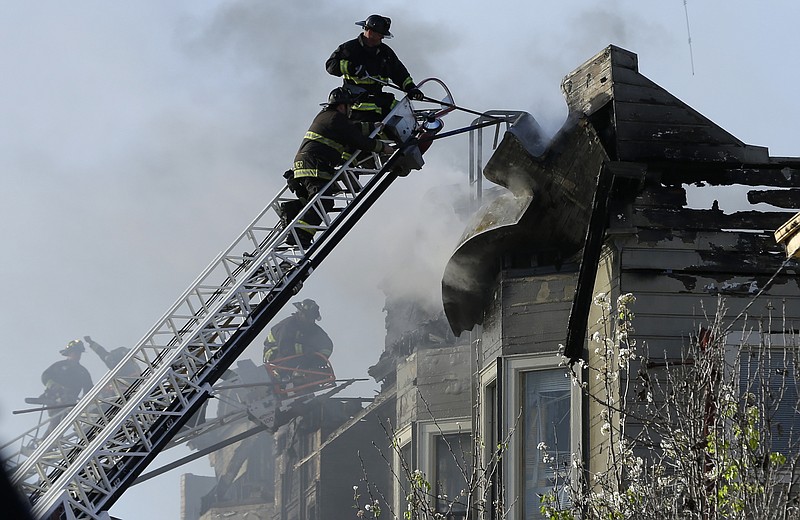 
              Firefighters battle an early morning apartment fire Monday, March 27, 2017, in Oakland, Calif. (AP Photo/Ben Margot)
            