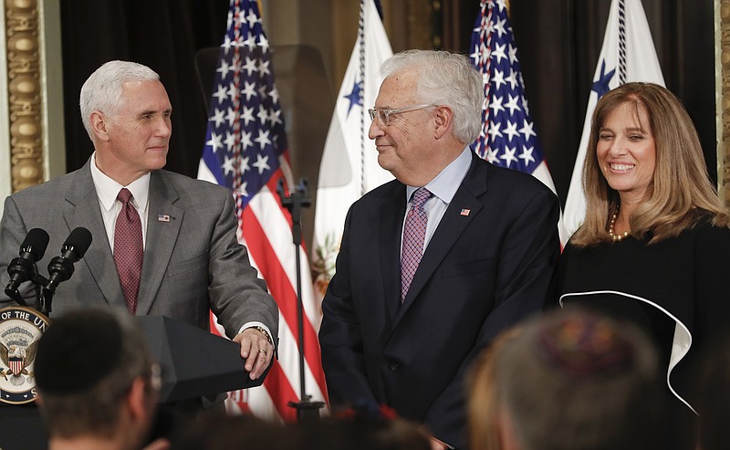
              Vice President Mike Pence, left, speaks before administering the oath of office to U.S. Ambassador to Israel David M. Friedman, center, accompanied by his wife Tammy, right, Wednesday, March 29, 2017, in the Eisenhower Executive Office Building on the White House complex in Washington. (AP Photo/Pablo Martinez Monsivais)
            