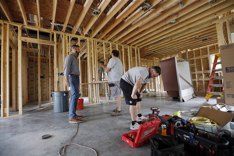 
              In this Friday, March 24, 2017, photo, Zach Tyson, left, owner of Tyson Construction, talks to electricians in a home he is constructing in Destrahan, La. General contractors and other small businesses in the remodeling industry can look forward to strong growth in the coming years, but the big force behind that business may be surprising: baby boomers. Tyson estimates that between 30 percent and 40 percent of his revenue is coming from boomer renovations, up from 15 percent to 20 percent five years ago. (AP Photo/Gerald Herbert)
            