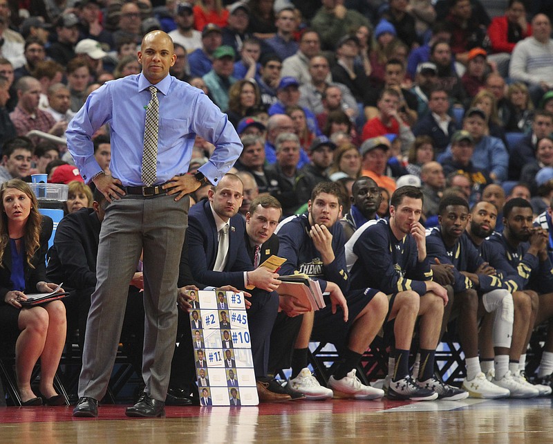 Mount St. Mary's men's basketball coach Jamion Christian watches the second half of the Mountaineers' NCAA tournament game against Villanova on March 16 in Buffalo, N.Y. Christian led his team to a First Four victory to earn the matchup with the top-seeded Wildcats.