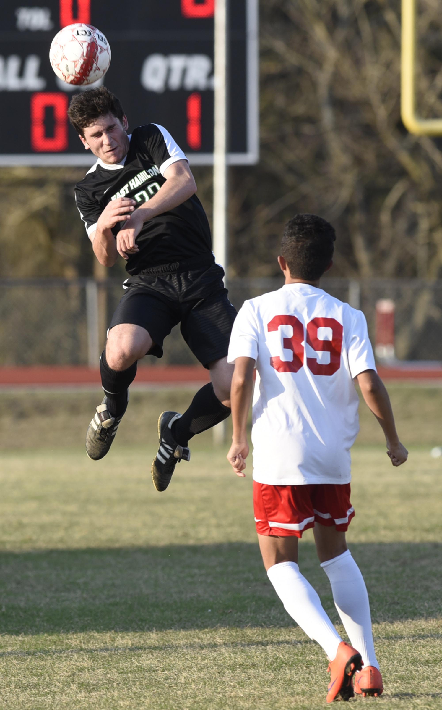 East Hamilton's Alex Segar heads the ball in front of Ooltewah's Muaz Alahmad during a game Wednesday at Ooltewah. The game was tied 1-1 at the end of regulation and overtime before the visiting Hurricanes won 5-3 in a penalty-kick shootout.
