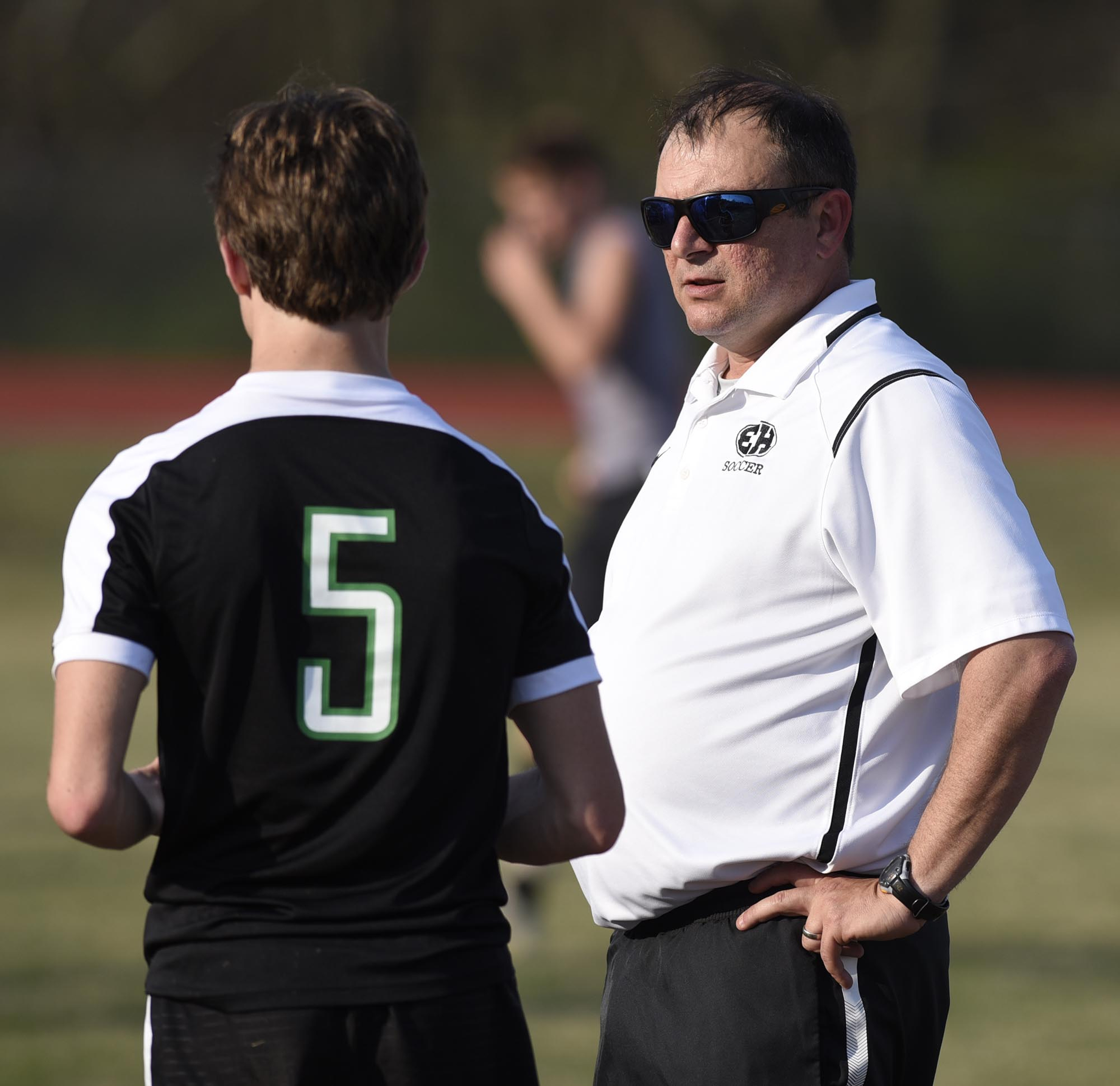East Hamilton coach Patrick Daverson talks with Cade Gregory (5) before the game. The East Hamilton Hurricanes visited the Ooltewah Owls in boys TSSAA soccer action on March 29, 2017.