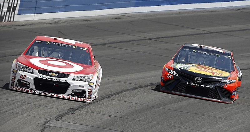 Kyle Larson leads Martin Truex Jr. toward the start/finish line at the end of the first stage of Sunday's NASCAR Cup Series race at Auto Club Speedway in Fontana, Calif. Larson went on to win the race, completing a dominating weekend in which he started Sunday's race on the pole and also won Saturday's Xfinity Series race.