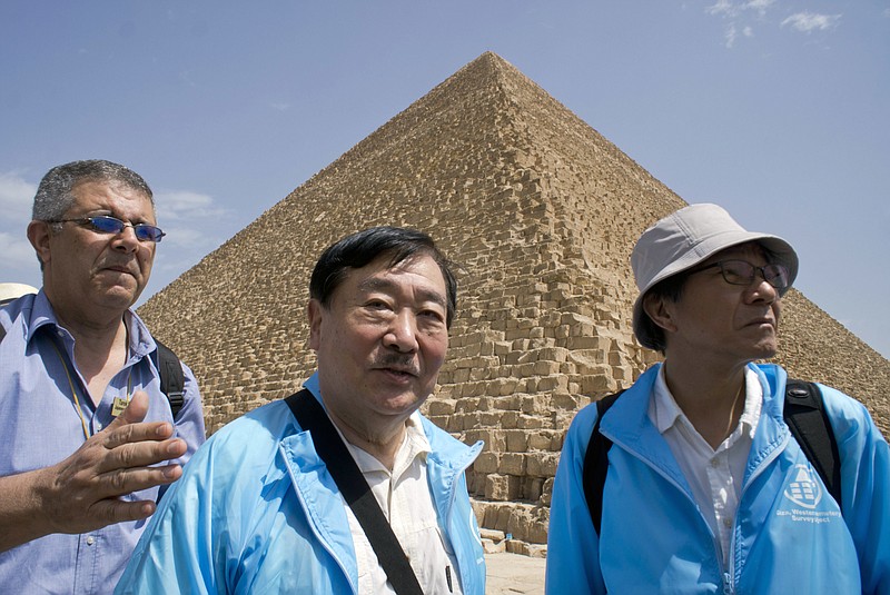 
              Sakuji Yoshimura, the director of the Institute of Egyptology, Waseda University, center, leaves the site of Cheops' second solar boat below the Pyramids site in Giza, Egypt, Wednesday, March 29, 2017. Egypt is inaugurating its largest on-site antiquities laboratory, to restore the second ceremonial boat of Pharaoh Cheops, known for building the largest of Egypt's iconic pyramids. The project, funded by the Japan International Cooperation Agency and the Higashi Nippon International University, is set to complete the initial phase of repairs of the 4,500-year-old vessel by 2020. (AP Photo/Amr Nabil)
            
