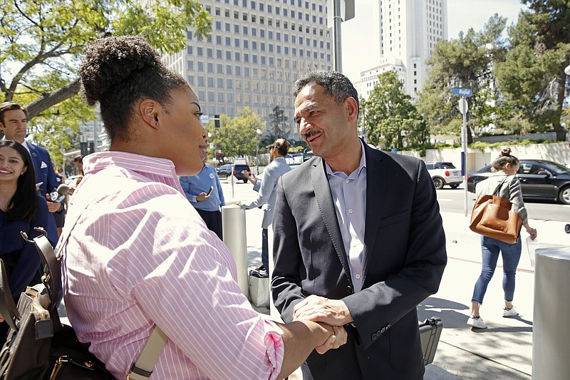 
              Dr. Asif Mahmood, right, a physician who came to the U.S. from Pakistan, greets supporters as he announces he is joining the 2018 race for California's lieutenant governor in front of the downtown federal building that houses a U.S. Immigration and Customs Enforcement field office in Los Angeles Wednesday, March 29, 2017. Mahmood is promising to run on his Muslim faith, immigrant past and career as a health care provider. (AP Photo/Nick Ut)
            