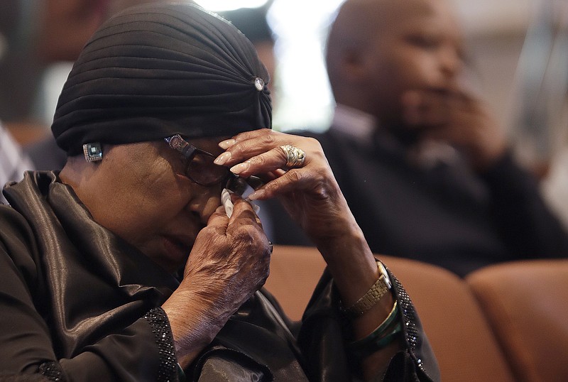 
              Former wife of the late former President Nelson Mandela, Winnie Madikizela-Mandela, listens to speeches during the memorial service for Ahmed Kathrada, at the Nelson Mandela Foundation in Johannesburg, South Africa, Tuesday, March 28, 2017. Anti-apartheid activist Ahmed Kathrada, who spent 26 years in jail - many of them alongside Nelson Mandela - for working to end South Africa's previous white minority rule, died in Johannesburg on Tuesday morning. He was 87 years old. (AP Photo/Themba Hadebe)
            