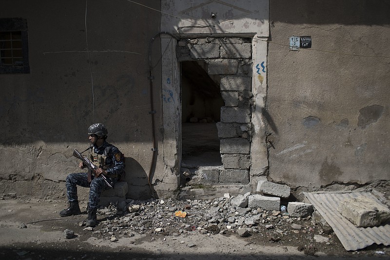 
              A federal policeman takes a break from inspecting houses during fighting against Islamic State militants on the western side of Mosul, Iraq, Wednesday, March 29, 2017. (AP Photo/Felipe Dana)
            