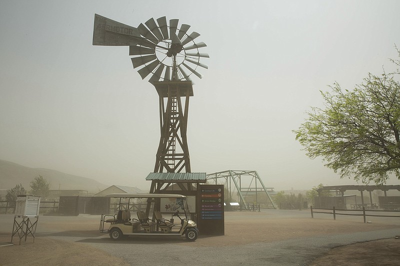 
              This photo taken March 23, 2017, shows sustained 43 mile per hour winds with 58 mile per hour gusts picked up dust obscuring both the Organ Mountains and A Mountain from view at the New Mexico Farm and Ranch Heritage Museum in Las Cruces, N.M. Not unlike a flash mob gathering in a public place to briefly capture the attention of unsuspecting passers-by, the ingredients in this case — warm temperatures and a lack of rain — came together quickly in New Mexico. It’s called a flash drought.  (Josh Bachman /The Las Cruces Sun-News via AP)
            
