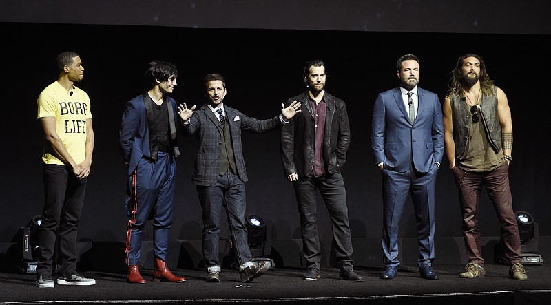 
              Zack Snyder, center, director of the upcoming film "Justice League," addresses the audience with cast members, from left, Ray Fisher, Ezra Miller, Henry Cavill, Ben Affleck and Jason Momoa during the Warner Bros. Pictures presentation at CinemaCon 2017 at Caesars Palace on Wednesday, March 29, 2017, in Las Vegas. (Photo by Chris Pizzello/Invision/AP)
            