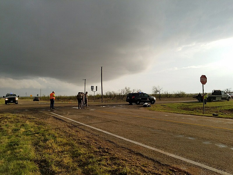 Texas Department of Public Safety troopers investigate a two-vehicle crash that left several storm chasers dead Tuesday, March 28, 2017, near Spur, Texas. The storms spawned multiple funnel clouds and an occasional tornado in open areas of West Texas on Tuesday afternoon. The crash happened at a remote intersection near the town of Spur, about 55 miles southeast of Lubbock. (Ellysa Gonzalez/Lubbock Avalanche-Journal via AP)