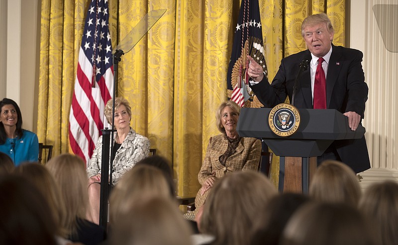 President Donald Trump speaks at a panel event on women's empowerment at the White House in Washington on Wednesday. First Lady Melania Trump made a rare White House appearance at the panel.