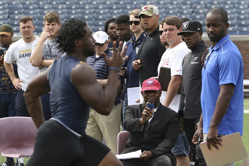 Staff Photo by Dan Henry / The Chattanooga Times Free Press- 3/30/17. NFL scouts watch as the University of Tennessee at Chattanooga seniors run drills at Finley Stadium on Thursday, March 30, 2017.