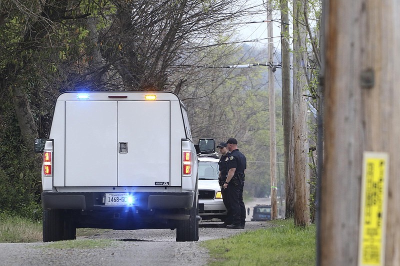 Staff Photo by Dan Henry / The Chattanooga Times Free Press- 3/30/17. Chattanooga Police gather evidence from a secondary scene early Thursday morning a block from an overnight shooting that occurred at 3500 Clio Avenue, near Rossville Blvd., and resulted in one dead and one injured. 