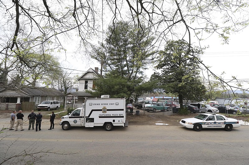 Staff Photo by Dan Henry / The Chattanooga Times Free Press- 3/30/17. Chattanooga Police gather evidence from a secondary scene early Thursday morning a block from an overnight shooting that occurred at 3500 Clio Avenue, near Rossville Blvd., and resulted in one dead and one injured. 