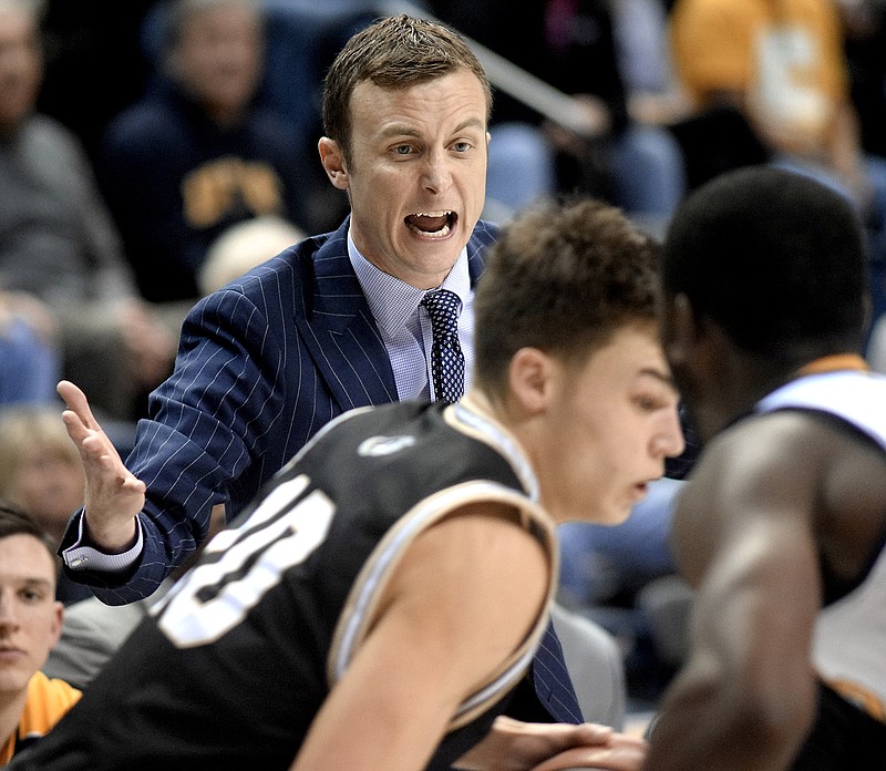 Matt McCall coaches the UTC men's basketball team during a SoCon game against Wofford at McKenzie Arena in January. McCall was hired as head coach at UMass on Wednesday after two seasons leading the Mocs.