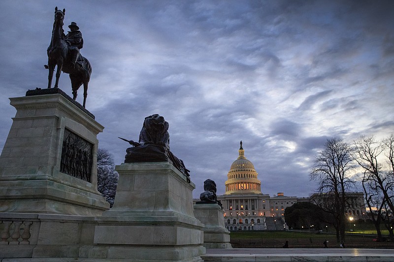 
              The Capitol, with a statue of Civil War General Ulysses S. Grant, left, is seen at dawn in Washington, Thursday, March 30, 2017. (AP Photo/J. Scott Applewhite)
            