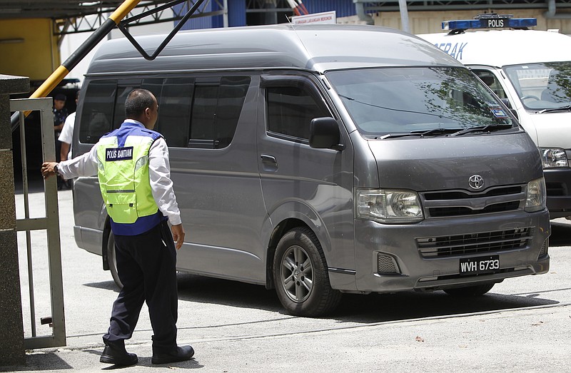 
              An unidentified van believed to be carrying the body of Kim Jong Nam comes out from the forensic department at Kuala Lumpur Hospital in Kuala Lumpur, Malaysia Thursday, March 30, 2017. Malaysian police on Thursday stopped guarding the morgue that held the body of North Korean leader Kim Jong Un’s murdered half-brother, after the van departed amid reports that his remains will leave the country. Shortly after the van left the hospital, police left the building and the morgue was reopened to the public.(AP Photo/Daniel Chan)
            