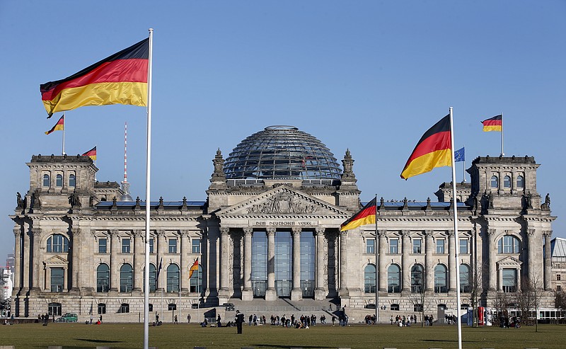 
              FILE - In this March 5, 2013 file photo German flags fly in front of the Reichstag building, host of the German Federal Parliament Bundestag, in Berlin, Germany. A top police official says a recent hacking attack on the German Parliament may have led to a "significant drain of data" which may be used to try influence the outcome of the country's general election in September. Holger Muench, the head of Germany's Federal Criminal Police Office, didn't tell reporters Thursday, March 30, 2017 who might have been behind the most recent hacking attack. The offices of at least 10 members of Parliament were attacked last month, the German news agency dpa reported.  (AP Photo/Michael Sohn,file)
            