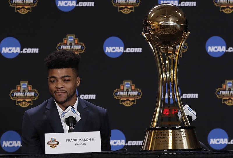 Kansas' Frank Mason III stands answers questions with his Associated Press Player of the Year trophy at a news conference Thursday, March 30, 2017, in Glendale, Ariz. (AP Photo/Matt York)