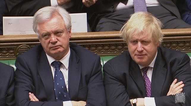
              Britain's Brexit Secretary David Davis, left, and Foreign Secretary Boris Jonhson  listen to Prime Minister Theresa May as she speaks in the House of Commons in London  in this image taken from video  Wednesday March 29, 2017. May will announce to Parliament that Britain is set to formally file for divorce from the European Union Wednesday, ending a 44-year relationship, enacting the decision made by U.K. voters in a referendum nine months ago and launching both Britain and the bloc into uncharted territory.  (Parliamentary Recording Unit  via AP)
            