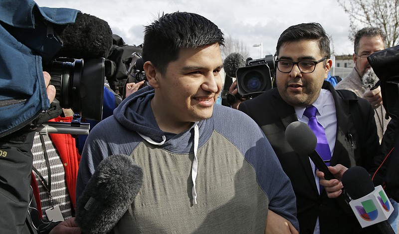 
              Daniel Ramirez Medina, center, briefly talks to reporters as he walks with his attorney, Luis Cortes, right, after Ramirez was freed from custody at the Northwest Detention Center in Tacoma, Wash., Wednesday, March 29, 2017. Ramirez had spent more than six weeks in immigration detention despite his participation in a program designed to prevent the deportation of those brought to the U.S. illegally as children. (AP Photo/Ted S. Warren)
            