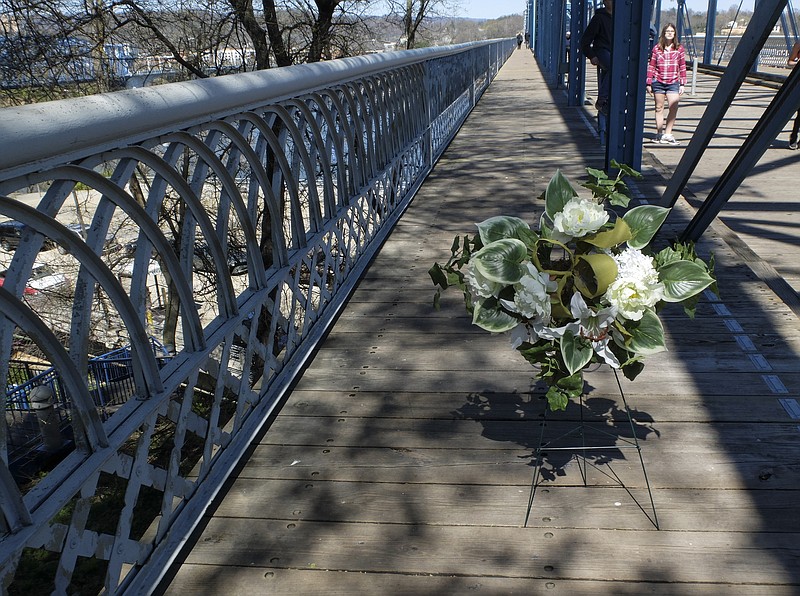 A wreath of flowers rests on the Walnut Street Bridge Sunday, Mar. 19, to mark the 111th anniversary of the lynching of Ed Johnson.