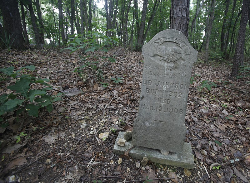 Pictured is the headstone of Ed Johnson {CQ}, who was lynched on the Walnut Street Bridge in 1906, on Tuesday, May 29, 2012. Pleasant Garden cemetery, a historically black cemetery, has been seemingly neglected for decades, despite the occasional surge of community interest. David Young {CQ}, a resident of the Ridgeside community whose home backs onto the cemetery property, has been fighting the underbrush and rampant foliage growth for three decades.