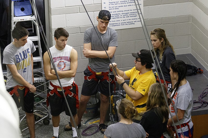 Students listen to a belay lesson during a UTC Wild program at the climbing facilities inside UTC's Aquatic Recreation Center.