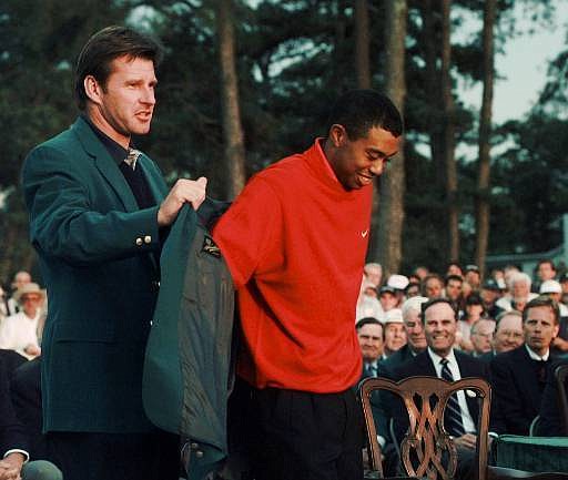 
              In this April 13,1997, file photo, Tiger Woods, 1997 Masters champion, receives his Green Jacket from the previous year's winner Nick Faldo, left, at the Augusta National Golf Club in Augusta, Ga. It has been 20 years since Woods won the Masters for the first time by a record 12 shots. (AP Photo/Amy Sancetta, File)
            