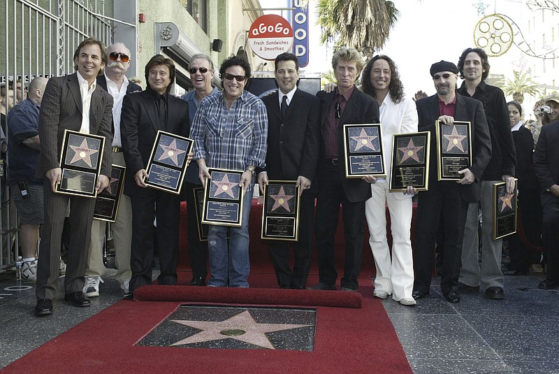 
              FILE - In this Jan. 21, 2005, file photo, members of the band Journey pose after receiving a star on the Hollywood Walk of Fame in Los Angeles. Keyboardist Jonathan Cain told the Dayton Daily News for a story published online on March 30, 2017, that former singer Steve Perry will be in attendance when the band is inducted into the Rock and Roll Hall of Fame on April 7, 2017. (AP Photo/Nick Ut, File)
            