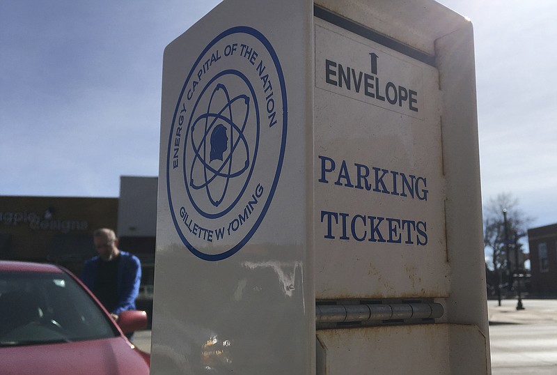 
              In this photo taken March 29, 2017, a parking ticket box in Gillette, Wyoming proclaims Gillette the "Energy Capital of the Nation" because of the area's huge coal mines and substantial oil, natural gas and uranium reserves. Many locals say after 500 coal-mine layoffs and the industry's worst year in decades, they're optimistic President Donald Trump's rollback of Obama administration climate and coal regulations will revitalize the industry. Economists are skeptical. (AP Photo/Mead Gruver)
            