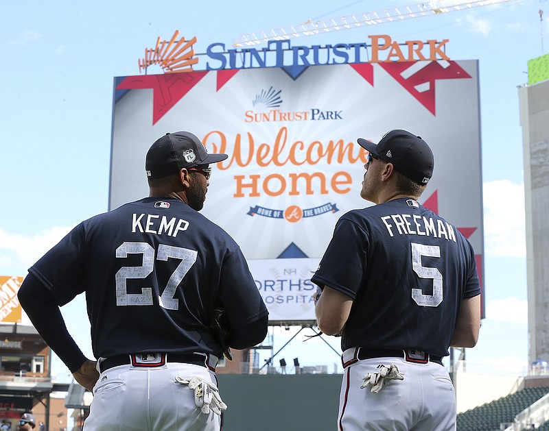 Atlanta Braves' Matt Kemp (27) and Freddie Freeman take in their new home as they prepare to play an exhibition  baseball game against the New York Yankees for the soft opening of SunTrust Park on Friday, March 31, 2017, in Atlanta. (Curtis Compton/Atlanta Journal-Constitution via AP)