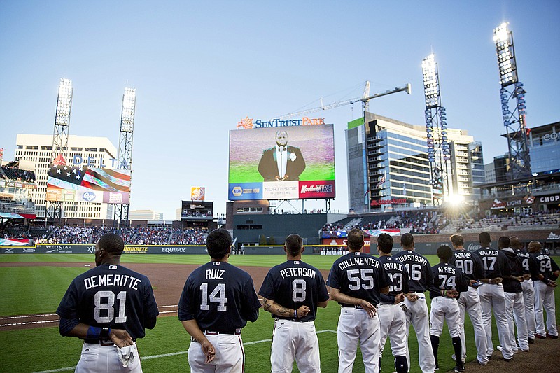 The Atlanta Braves stand for the National Anthem as the Braves open SunTrust Park, the team's new stadium, for an exhibition spring training baseball game against the New York Yankees in Atlanta, Friday, March 31, 2017. (AP Photo/David Goldman)