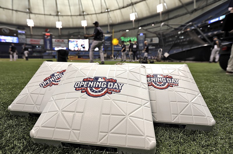 Opening Day bases sit in the foreground as the New York Yankees take batting practice before a baseball game against the Tampa Bay Rays, Sunday, April 2, 2017, in St. Petersburg, Fla. (AP Photo/Chris O'Meara)