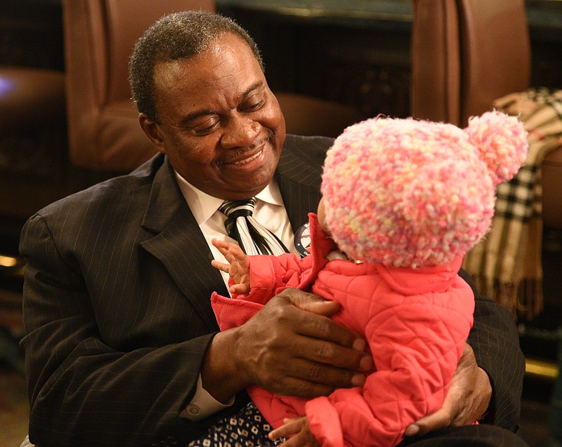 Chattanooga City Councilman Yusuf Hakeem holds his great-granddaughter, Addison Bone, as election returns rolled in during the March 7 municipal election.