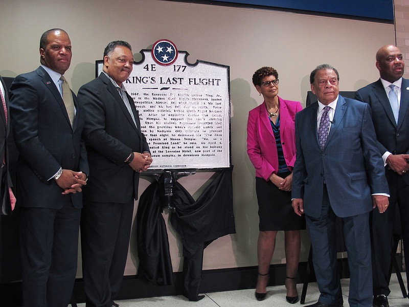 
              The Rev. Jesse Jackson, second from left, and Andrew Young, second from right, pose for photos after the unveiling of a historical marker at Memphis International Airport commemorating the final flight of slain civil rights leader Martin Luther King Jr. on Monday, April 3, 2017 in Memphis, Tenn. Also pictured are Operation Hope founder and CEO John Hope Bryant, far left, SunTrust Bank executive Johnny Moore, far right, and Memphis-Shelby County Airport Authority board member Pamela Clary, third from right. (AP Photo/Adrian Sainz).
            