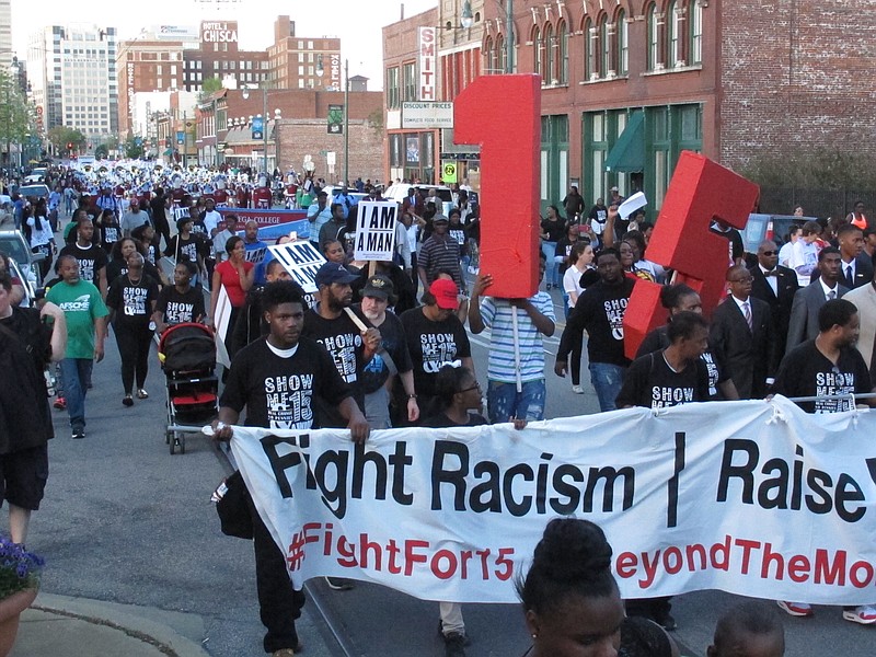 
              Supporters of the Black Lives Matter and Fight for $15 movements march down the streets of Memphis on the 49th anniversary of the assassination of civil rights leader Martin Luther King Jr. on Tuesday, April 4, 2017, in Memphis, Tenn. (AP Photo/Adrian Sainz)
            